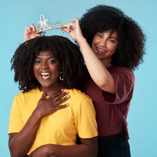 Happy women celebrating woman empowerment and friendship with tiara, diverse women enjoying joyful moment, empowerment and community spirit, Our World Nexus.